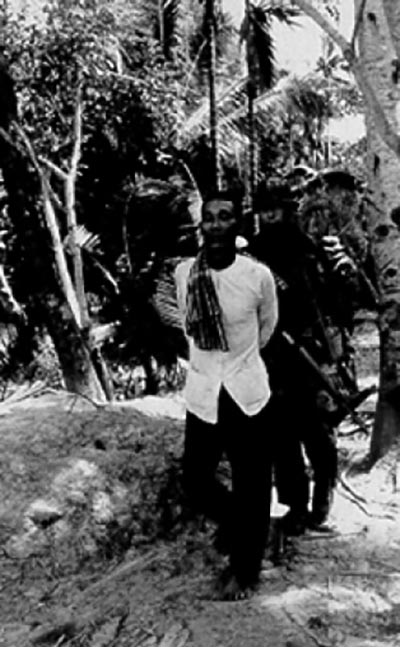 Operations under the Phoenix program sought to target and neutralize members of the Viet Cong infrastructure (VCI). A U.S. Navy SEAL in the Mekong Delta leads away a VC suspect.